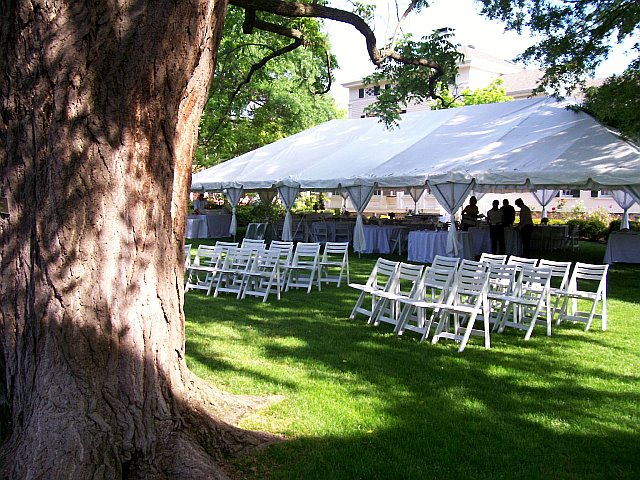 Above is a 30 x60 tent with ceremony chairs set up on the south side of the
